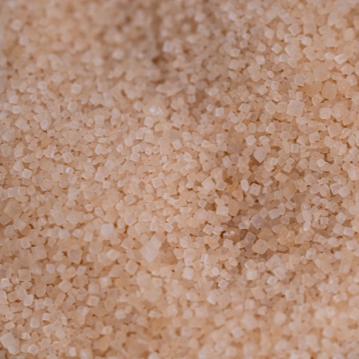 A close-up pile of organic coconut sugar granules